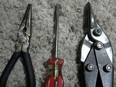 Needle nose pliers, screwdriver, and metal cutter Needle nose pliers, screwdriver, and metal cutter
